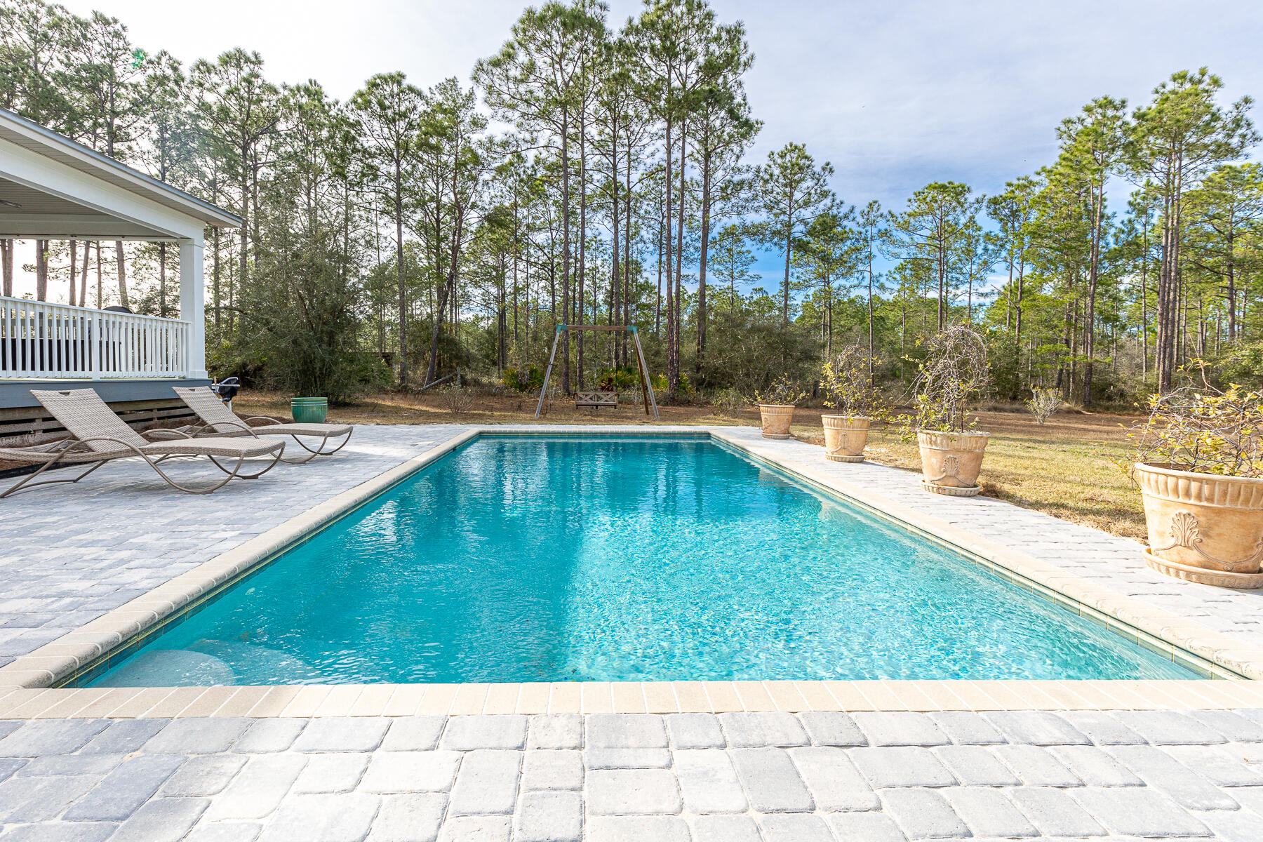 453 Don Graff Road Freeport, FL 32439 - Photo 36 of 59 a view of a swimming pool with lounge chair