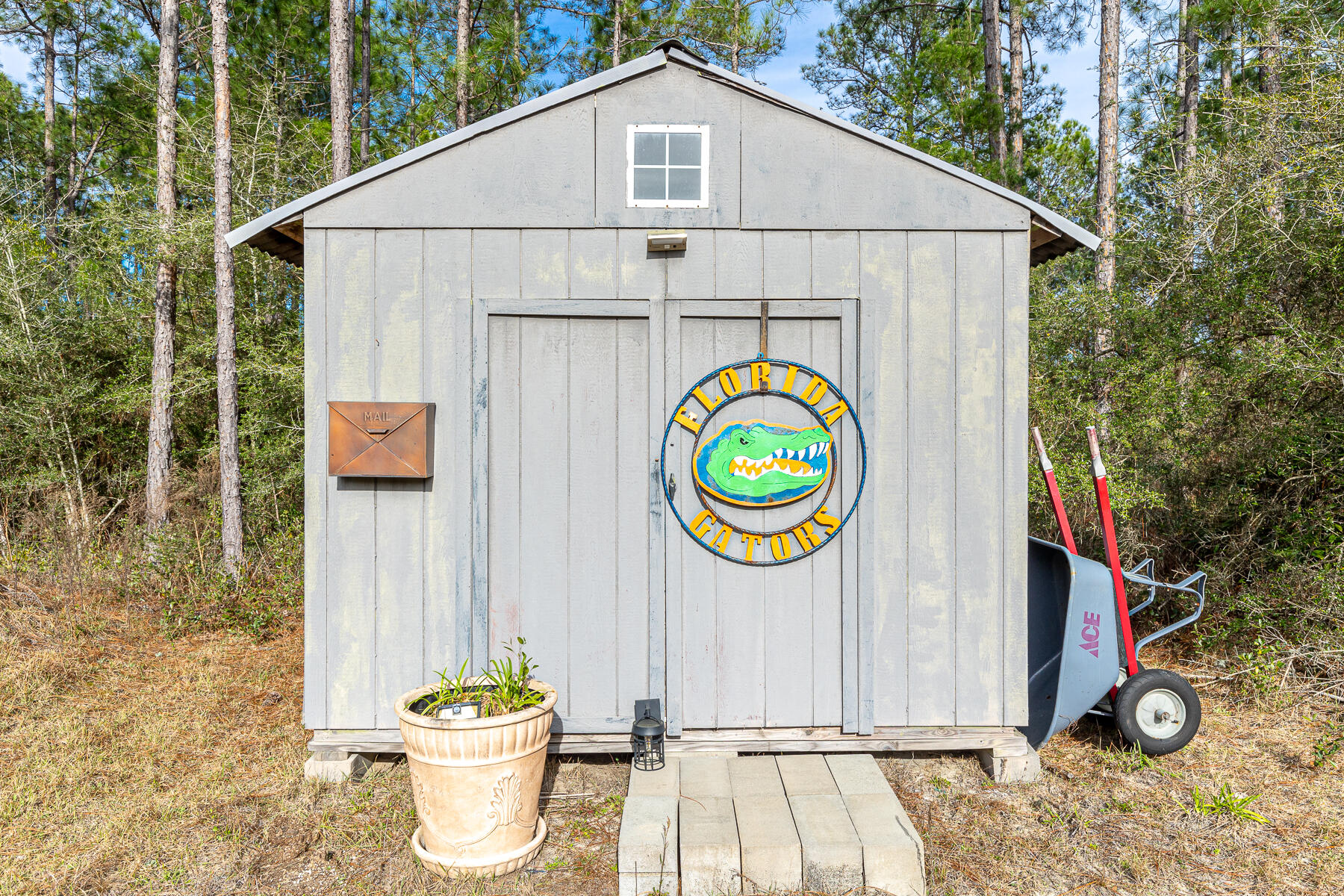 453 Don Graff Road Freeport, FL 32439 - Photo 50 of 59 a white house with wooden fence and a potted plant