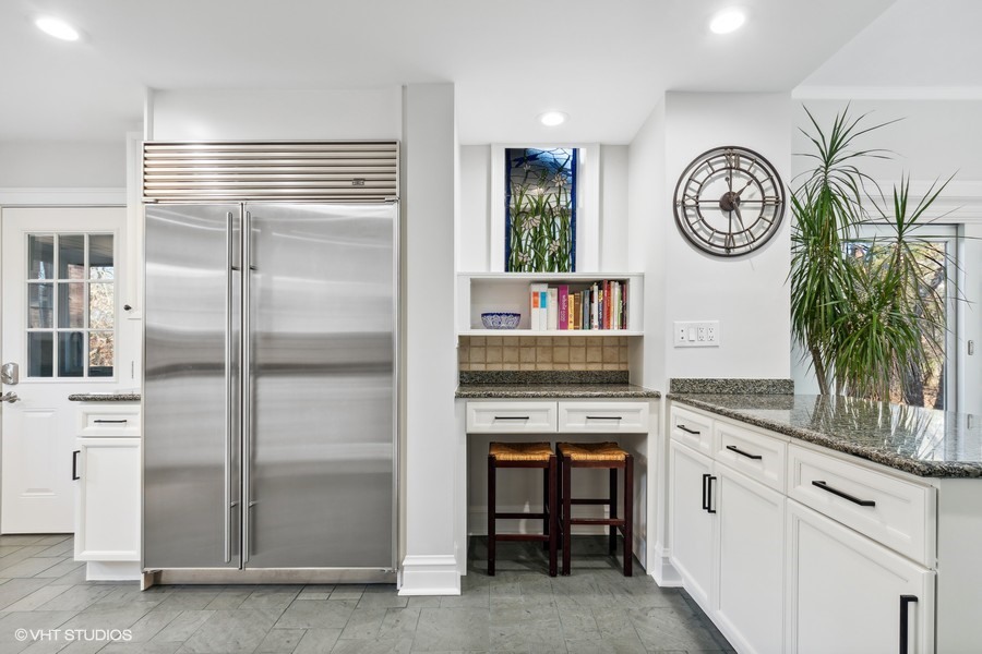 730 Sheridan Road Wilmette, IL 60091 - Photo 17 of 43 a kitchen with a refrigerator and a clock on the wall