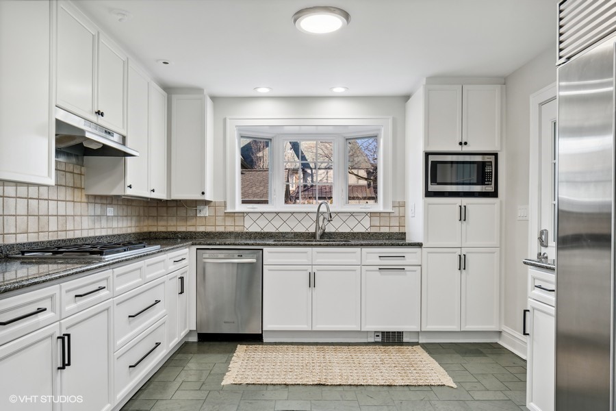 730 Sheridan Road Wilmette, IL 60091 - Photo 18 of 43 a kitchen with stainless steel appliances granite countertop a stove a sink and a refrigerator