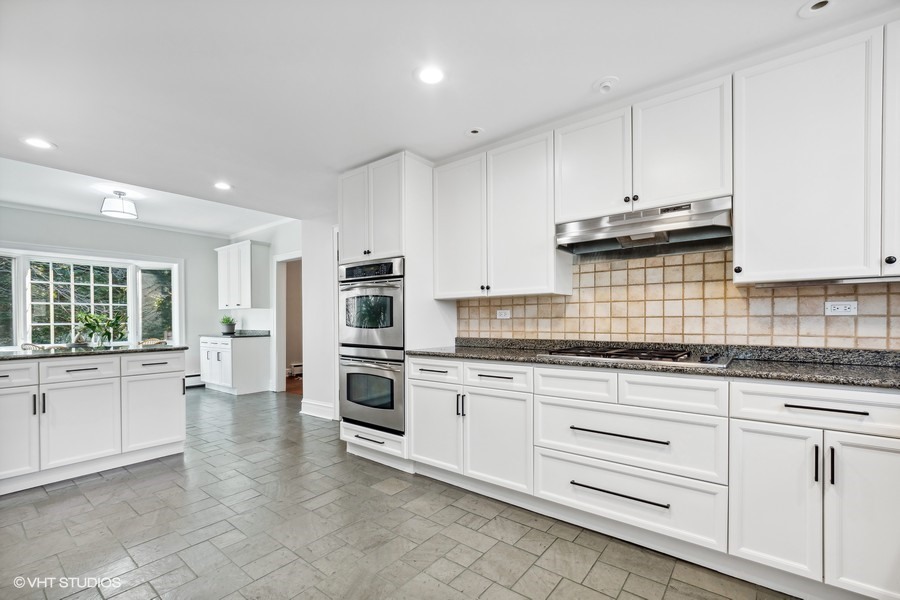 730 Sheridan Road Wilmette, IL 60091 - Photo 19 of 43 a kitchen with granite countertop white cabinets and white appliances