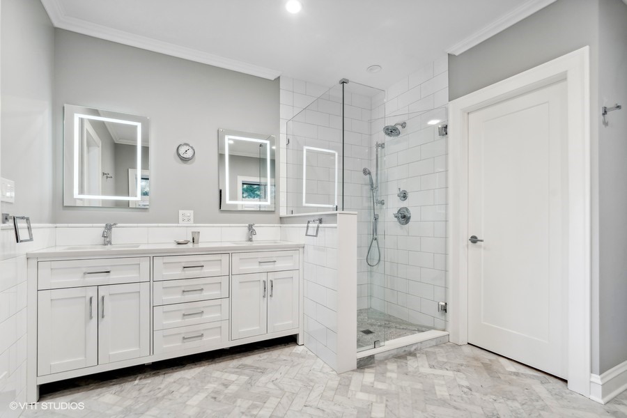 730 Sheridan Road Wilmette, IL 60091 - Photo 24 of 43 a spacious bathroom with a shower sink and mirror