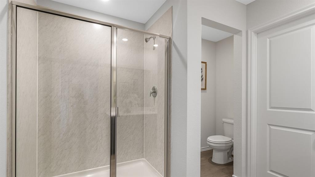 1667 Mantle Road Crandall, TX 75114 - Photo 12 of 20 Enclosed shower with glass sliding doors, textured shower surround, and chrome fixtures