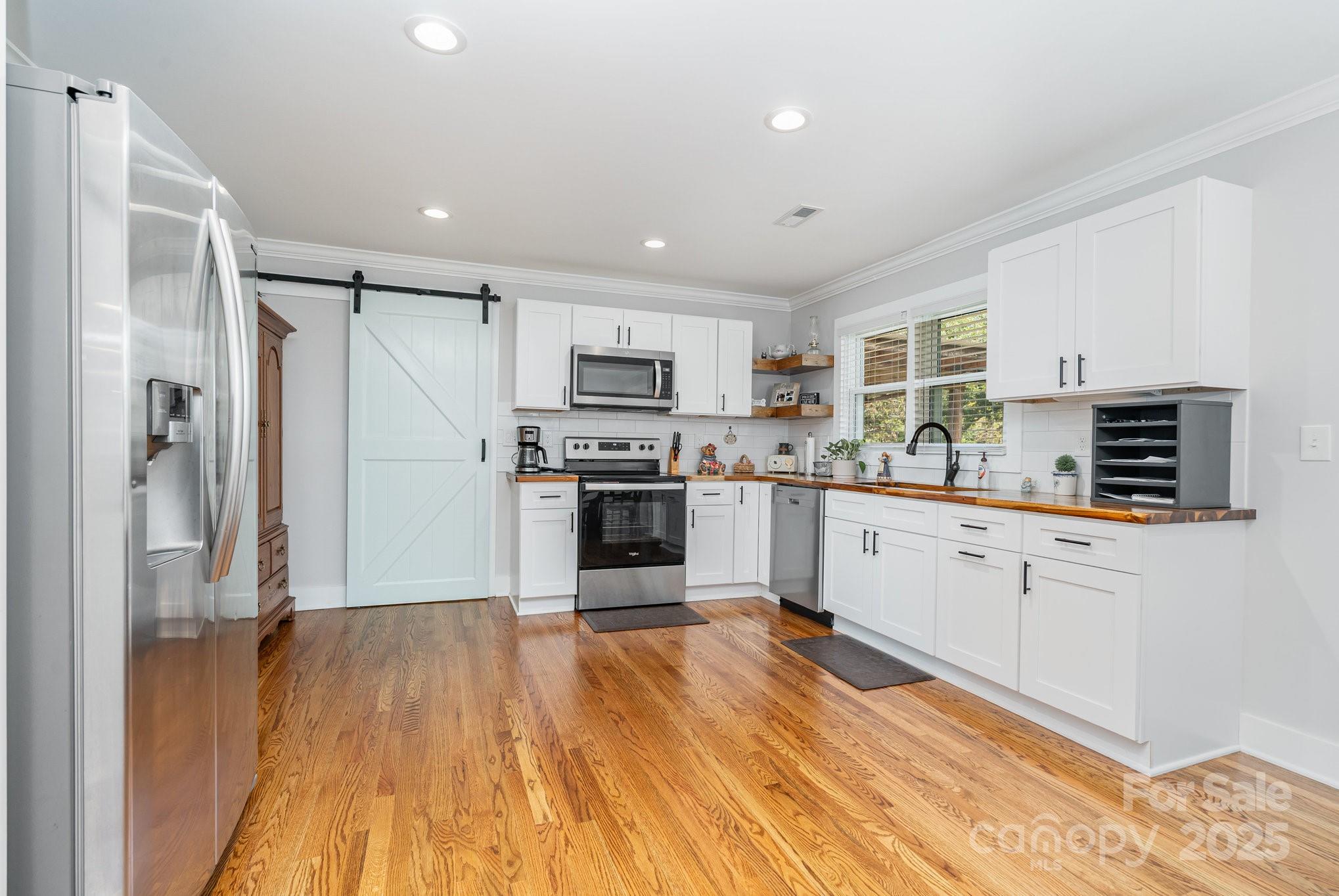 2295 Emanuel Church Road Rockwell, NC 28138 - Photo 13 of 33 a kitchen with stainless steel appliances a refrigerator and a stove top oven