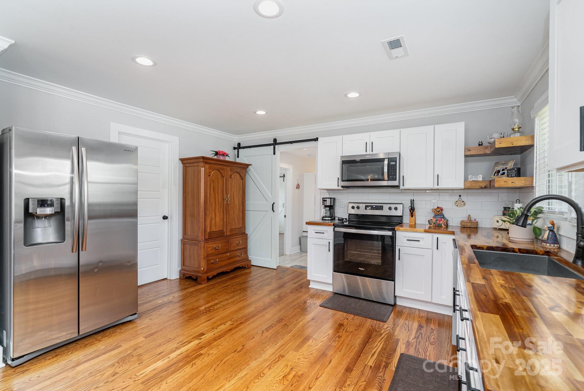 2295 Emanuel Church Road Rockwell, NC 28138 - Photo 14 of 33 a kitchen with granite countertop a refrigerator and a stove top oven