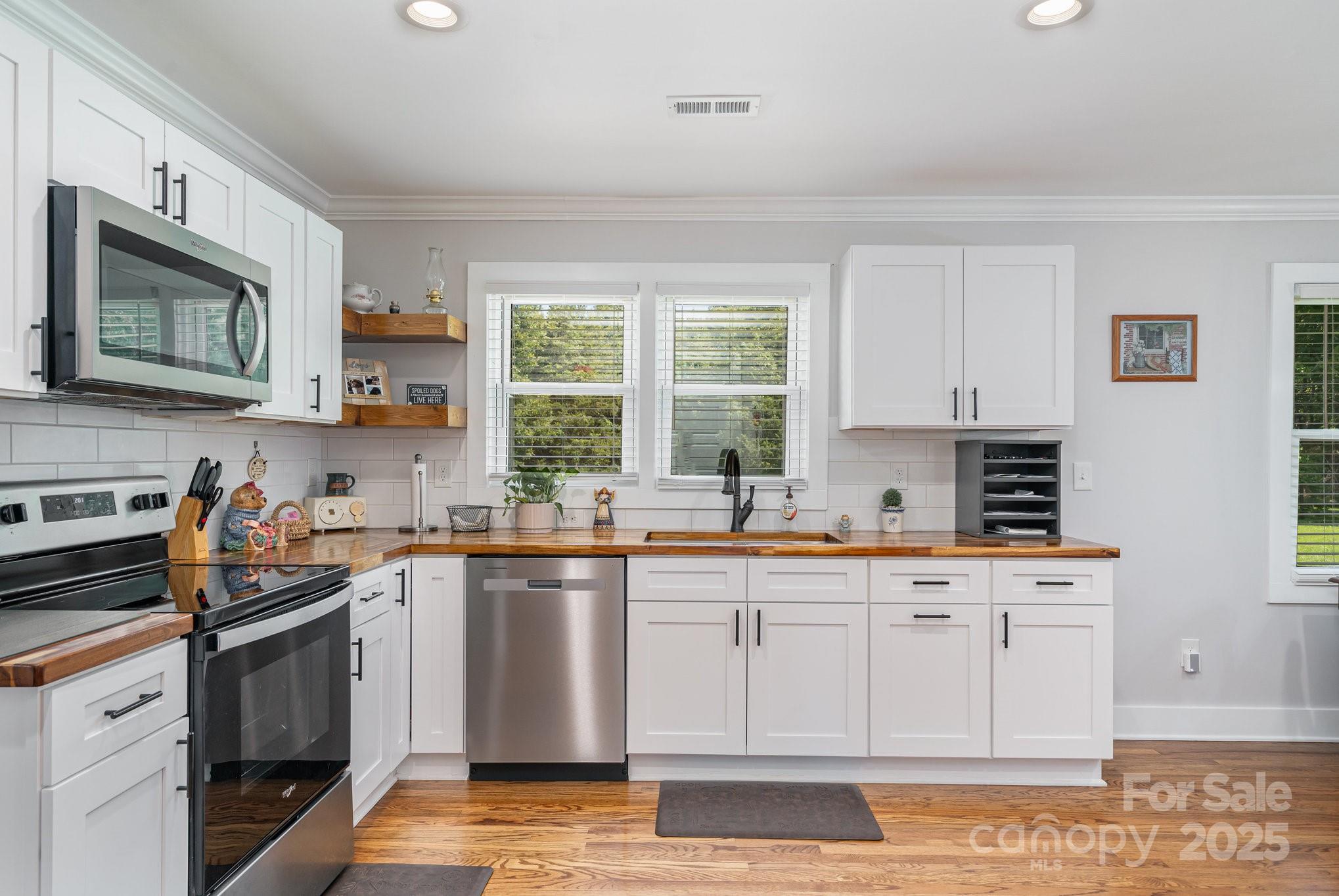 2295 Emanuel Church Road Rockwell, NC 28138 - Photo 15 of 33 a kitchen with stainless steel appliances granite countertop a stove a sink dishwasher and a microwave oven on the kitchen countertops