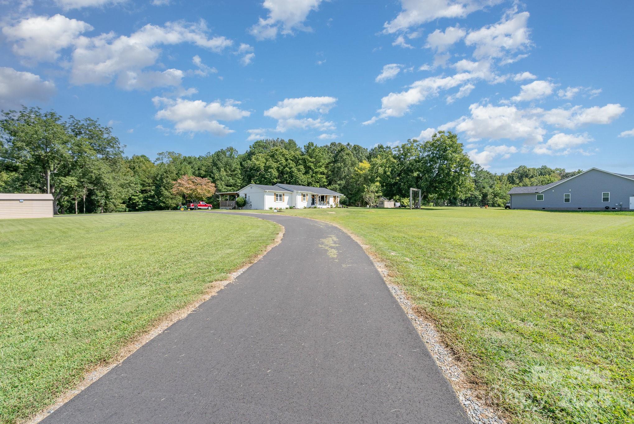 2295 Emanuel Church Road Rockwell, NC 28138 - Photo 2 of 33 a view of a lake with a yard