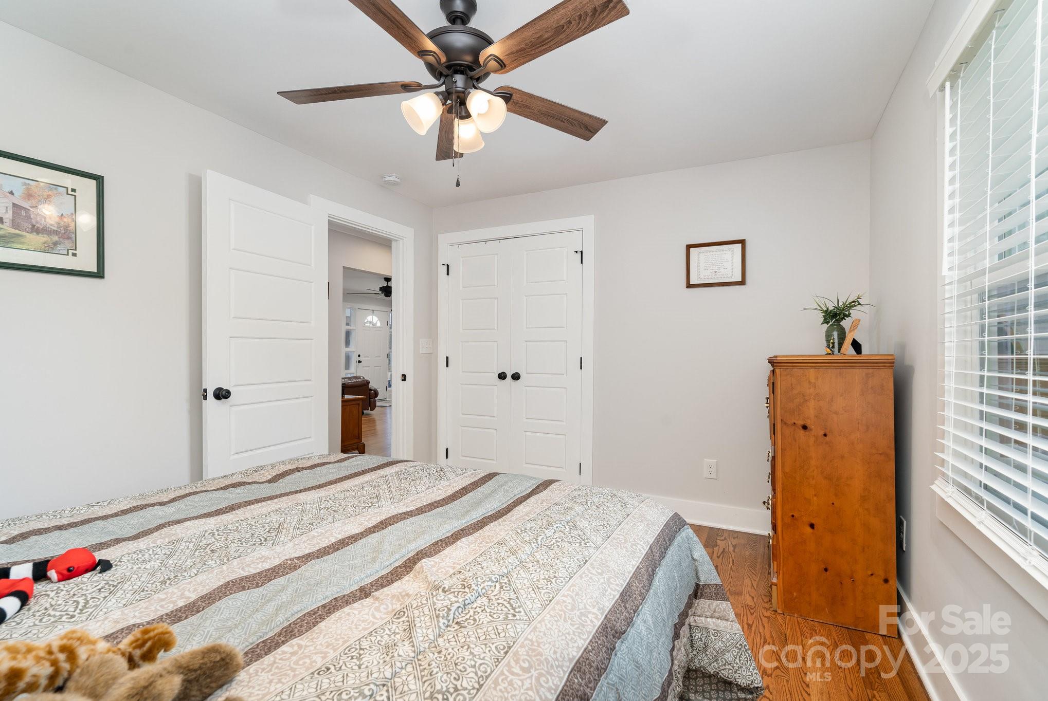 2295 Emanuel Church Road Rockwell, NC 28138 - Photo 21 of 33 a bedroom with a bed and a chandelier