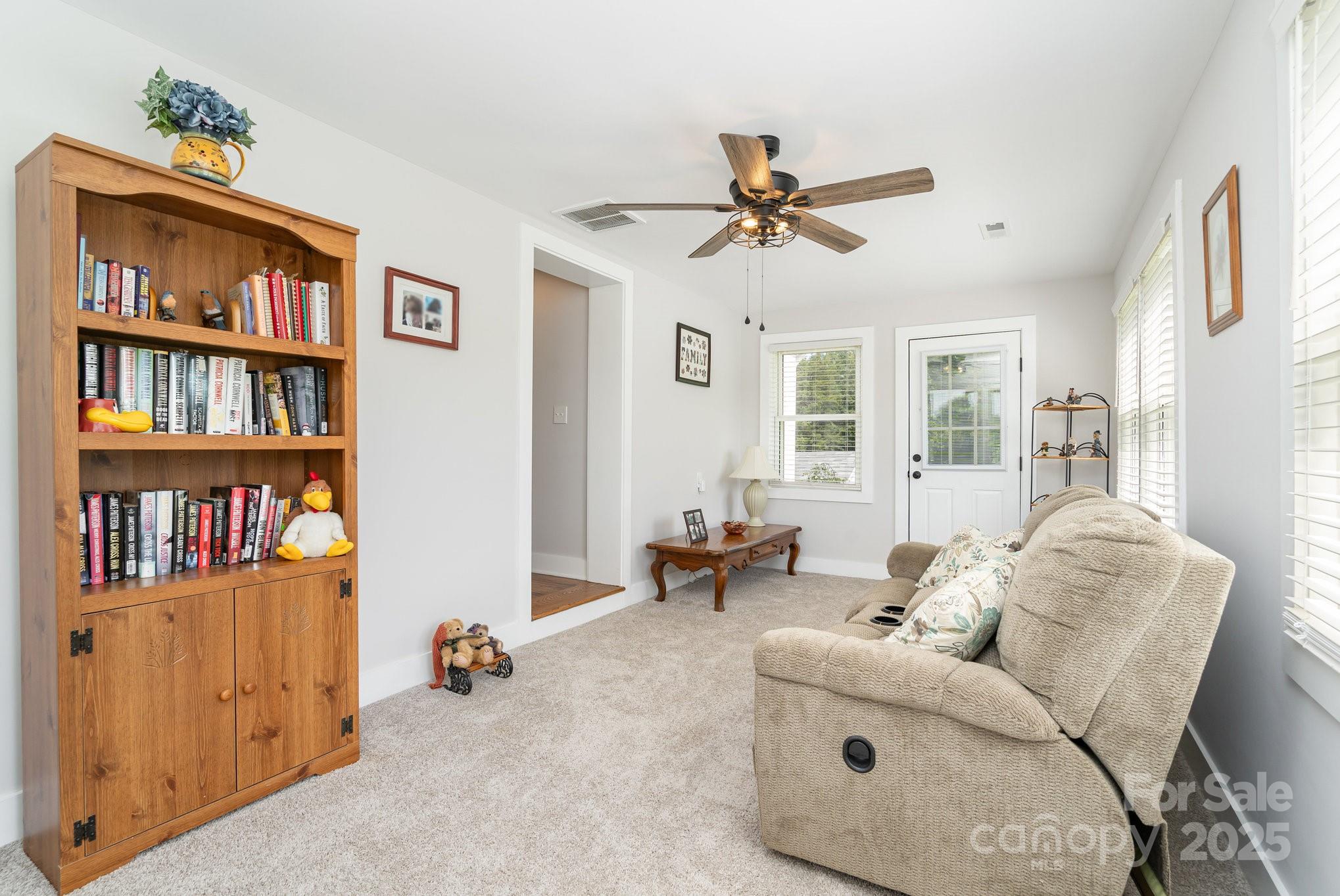 2295 Emanuel Church Road Rockwell, NC 28138 - Photo 26 of 33 a living room with furniture and a book shelf