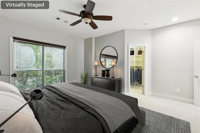 a bedroom with a large bed and a large window