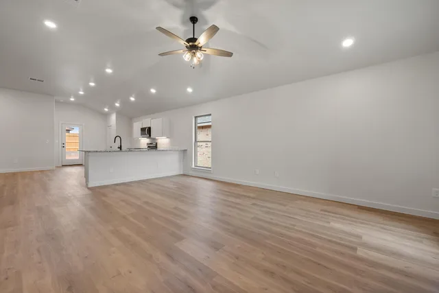 a view of a kitchen with a sink and a stove top oven