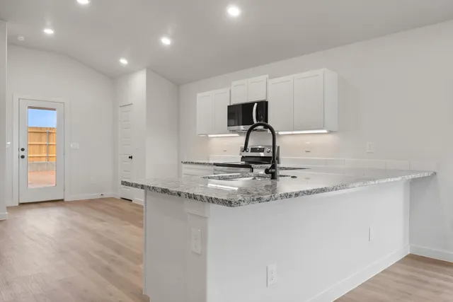 a view of a kitchen with a sink and a window