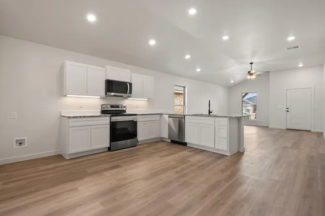 a kitchen with a white cabinets and white appliances