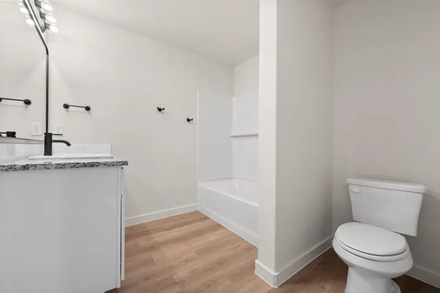 a bathroom with a toilet a sink and bathtub