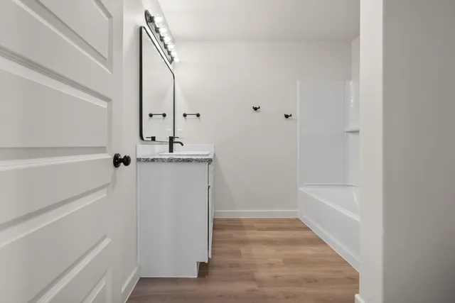 a bathroom with a bathtub and shower