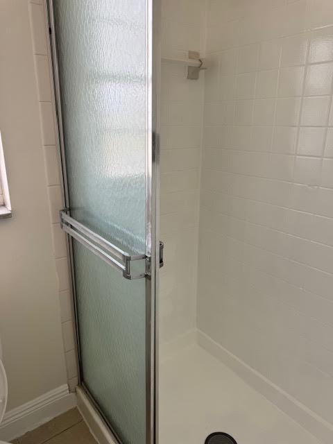 537 Northwest 46th Avenue Delray Beach, FL 33445 - Photo 15 of 20 a bathroom with a glass shower door