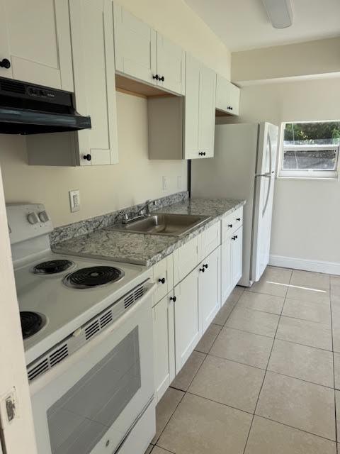 537 Northwest 46th Avenue Delray Beach, FL 33445 - Photo 4 of 20 a kitchen with granite countertop a sink stove and refrigerator