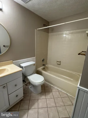 a bathroom with a toilet a sink and bathtub