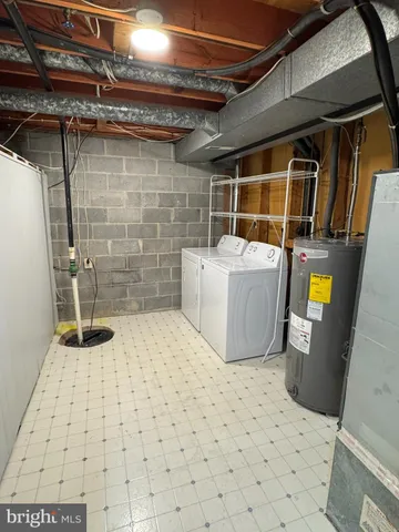 a room with a stove and white cabinets