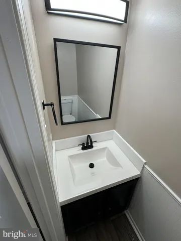 a bathroom with a sink a mirror and vanity