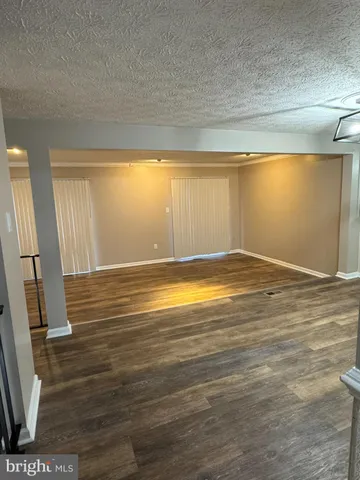 a view of room with window and wooden floor