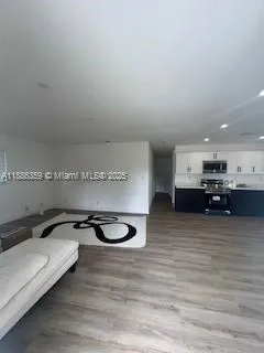 a view of a room with furniture and a flat screen tv