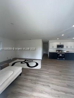 2201 Northwest 6th Court, Unit 2201 Fort Lauderdale, FL 33311 - Photo 2 of 8 a view of a room with furniture and a flat screen tv