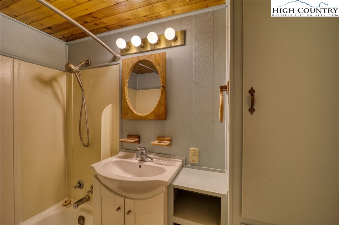 280 Chinkapin Ridge Road Seven Devils, NC 28604 - Photo 25 of 36 a bathroom with a sink mirror and shower