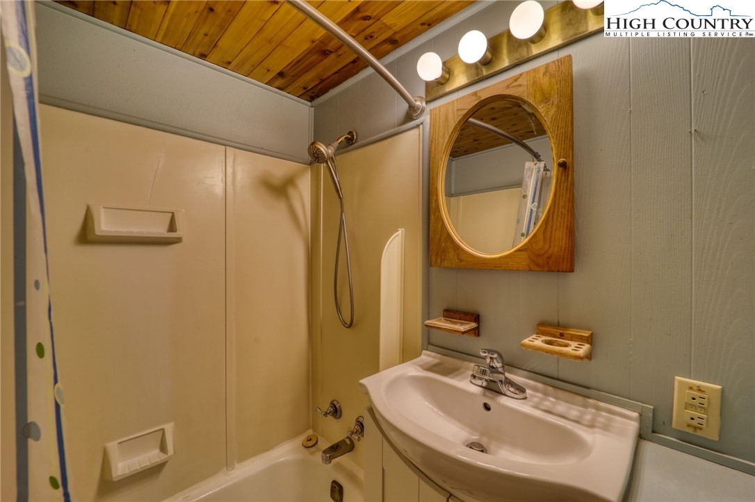 280 Chinkapin Ridge Road Seven Devils, NC 28604 - Photo 26 of 36 a bathroom with a sink and a mirror