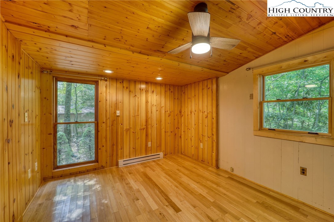 280 Chinkapin Ridge Road Seven Devils, NC 28604 - Photo 28 of 36 a view of an empty room with wooden floor and a window