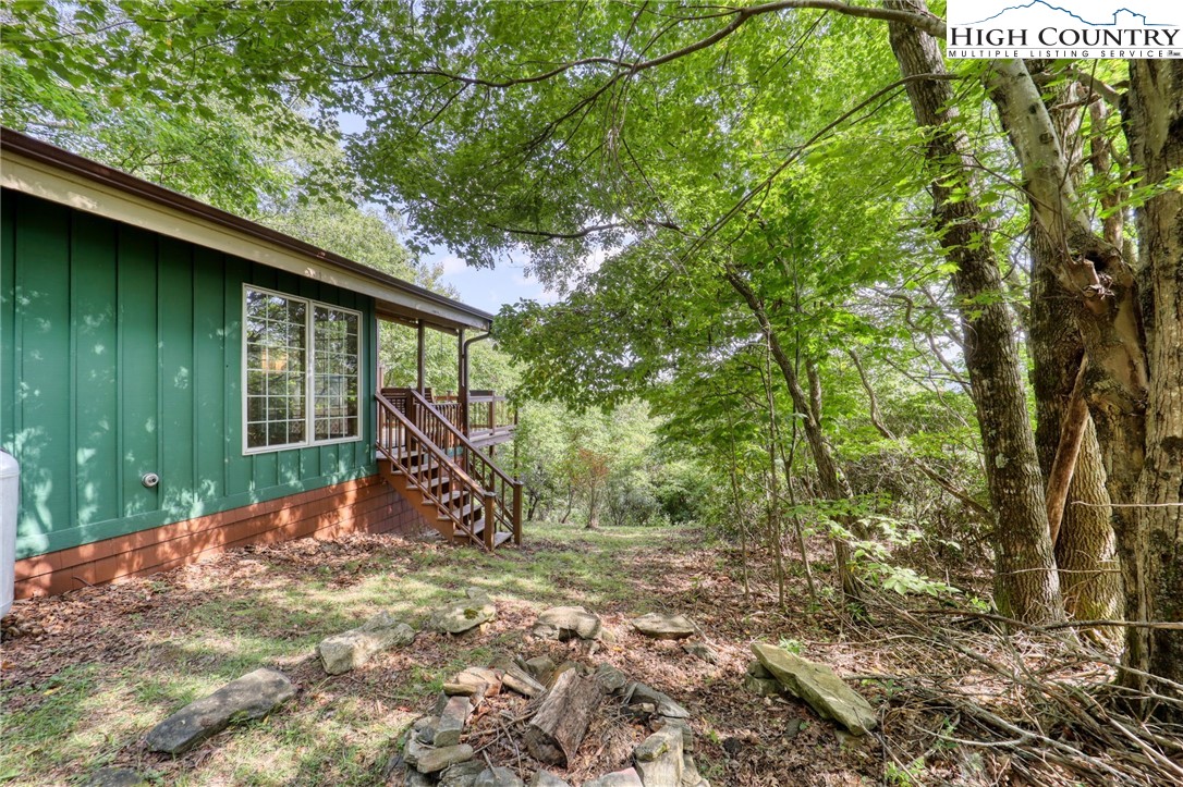 280 Chinkapin Ridge Road Seven Devils, NC 28604 - Photo 4 of 36 a view of a wooden house with a large tree