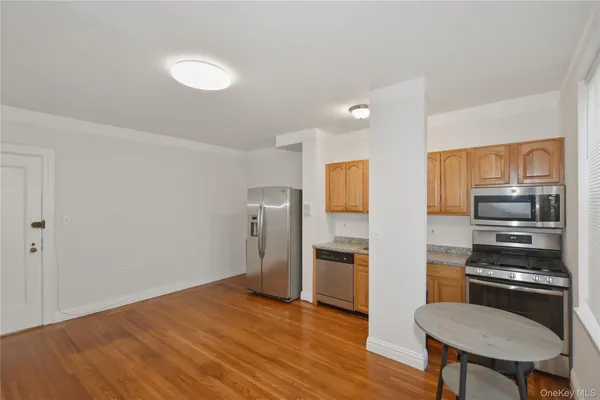 a kitchen with a refrigerator and a stove top oven
