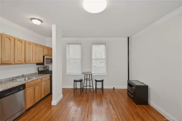 a kitchen with a wooden floor and white appliances