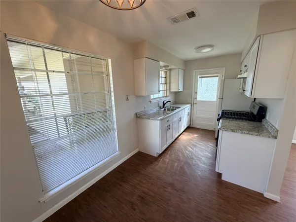 a living room with furniture window and wooden floor