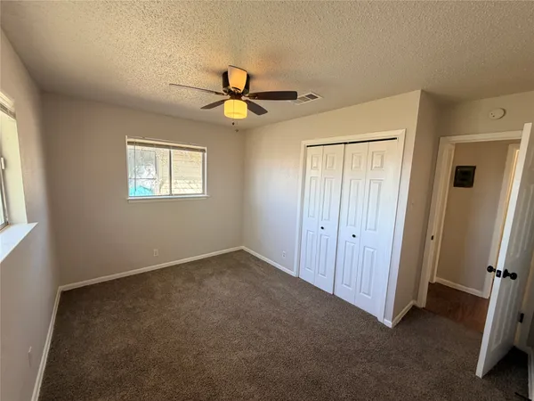 a view of room with a ceiling fan and a window