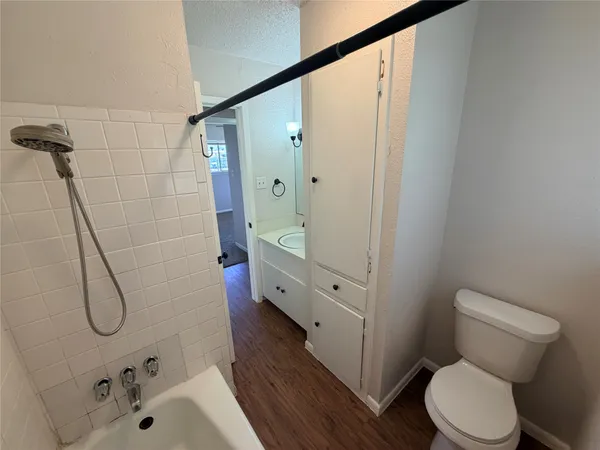 a bathroom with a shower toilet and sink