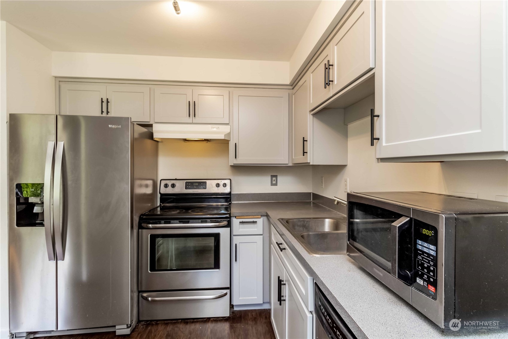 3816 Northeast 12th Street Renton, WA 98056 - Photo 12 of 39 a kitchen with stainless steel appliances a stove a microwave and a refrigerator
