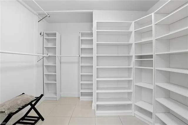 a view of walk in closet with empty racks