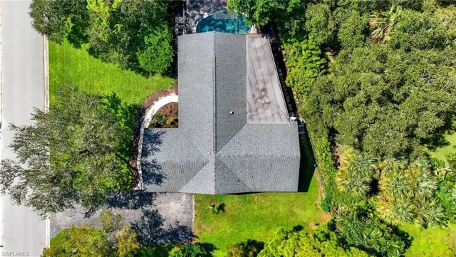 an aerial view of a house with a yard and garden