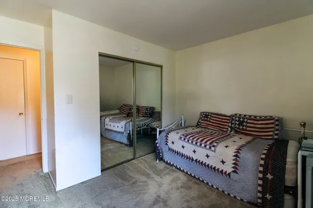 a bedroom with a bed and a mirror