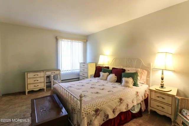 a bedroom with a bed and a night stand