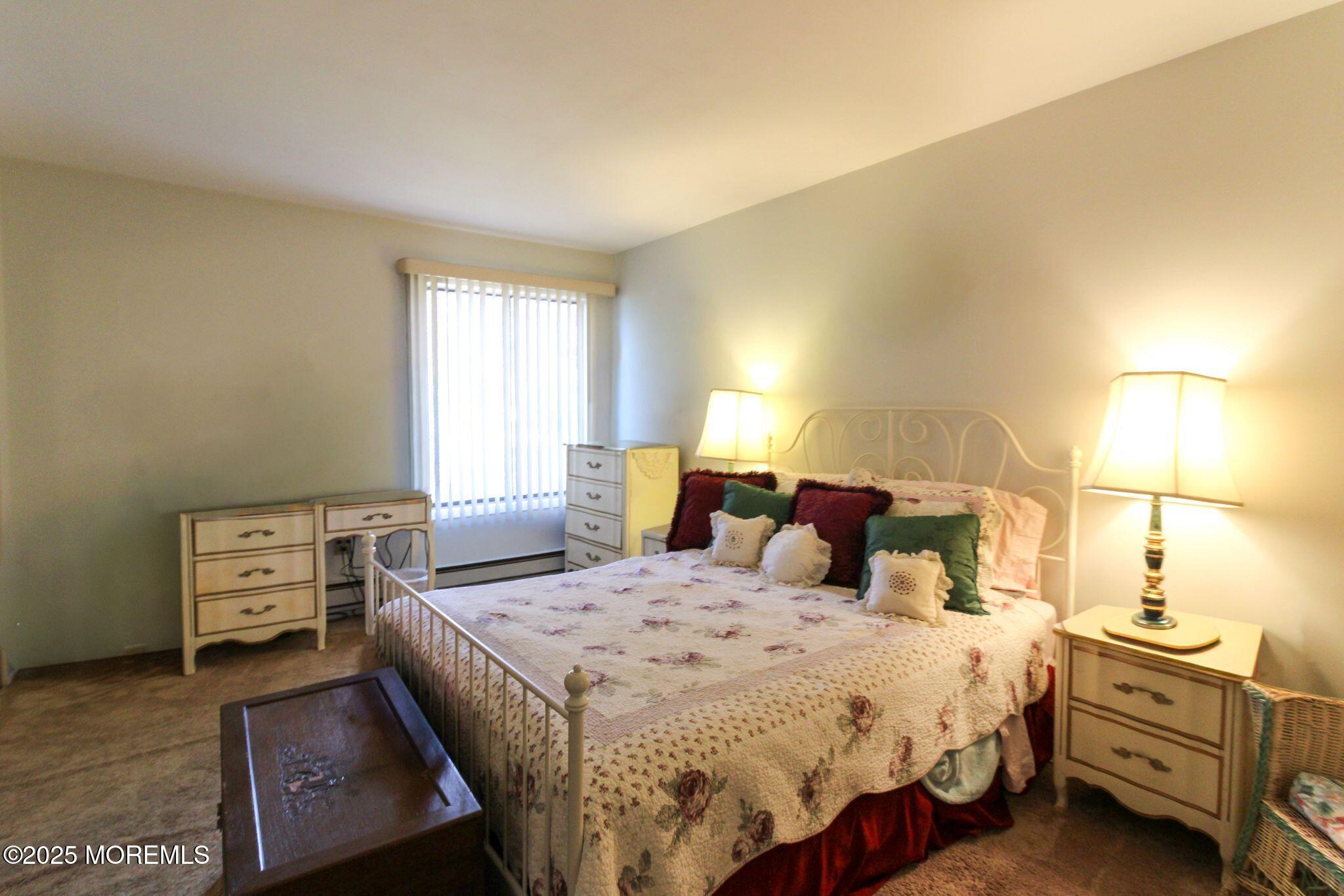 24 Meadow Green Circle, Unit A Manalapan, NJ 07726 - Photo 15 of 24 a bedroom with a bed and a night stand