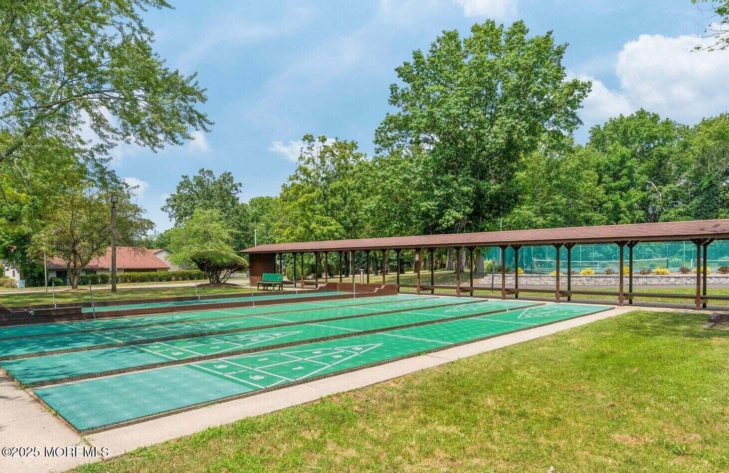 24 Meadow Green Circle, Unit A Manalapan, NJ 07726 - Photo 18 of 24 a front view of a house and a yard