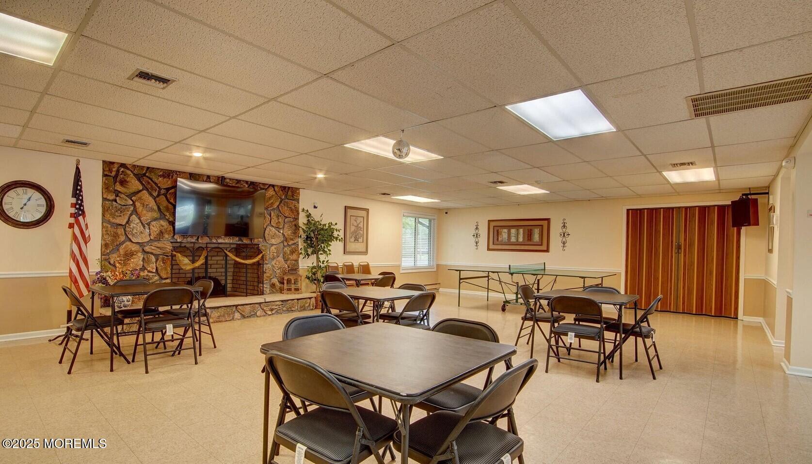 24 Meadow Green Circle, Unit A Manalapan, NJ 07726 - Photo 20 of 24 a living room with furniture a dining table and chairs