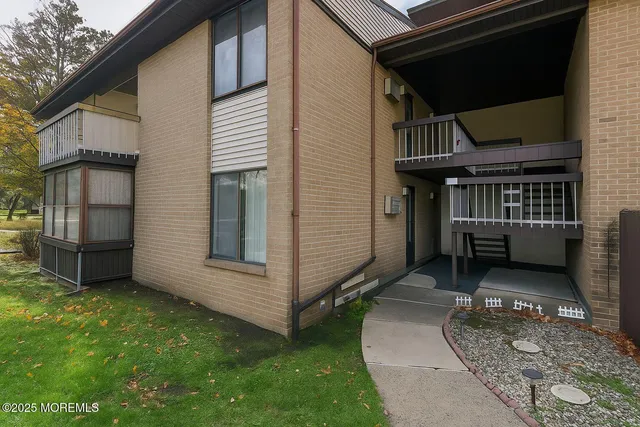 a view of a house with a small cabin and wooden fence