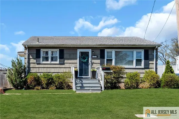 a view of a house with potted plants and a yard