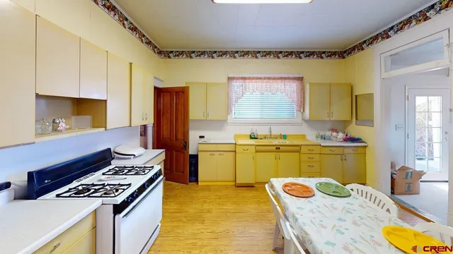 a kitchen with a stove a sink and a refrigerator