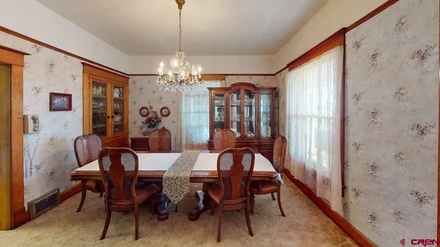a view of a dining room with furniture and window