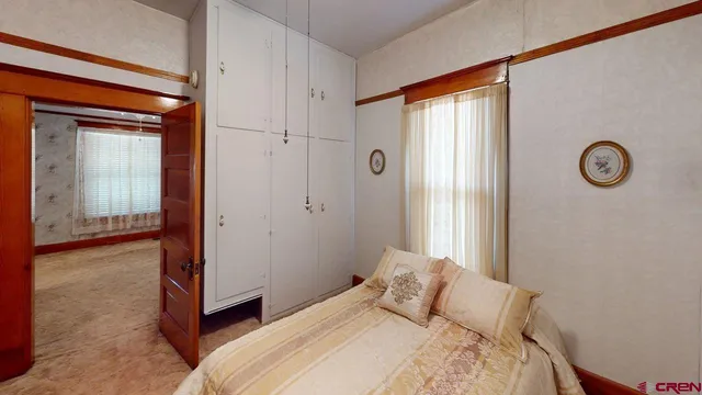 a bedroom with a bed and a window