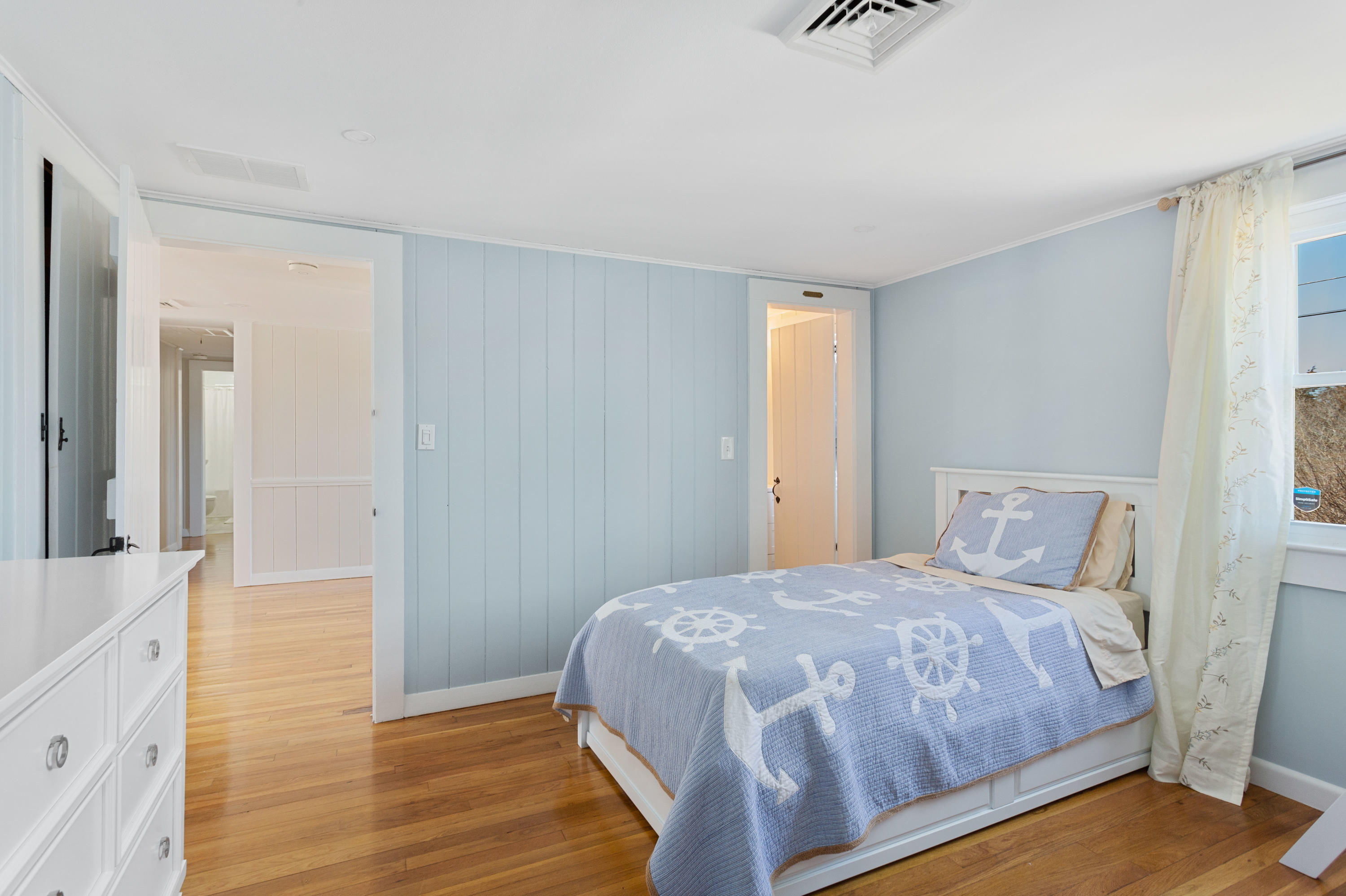 115 Seagull Road Chatham, MA 02633 - Photo 13 of 29 a bedroom with a bed and wooden floor